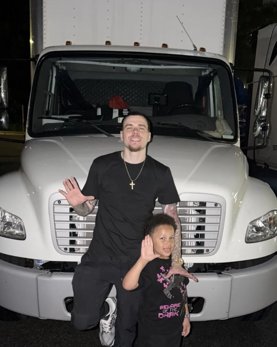 Anthony Schulz, founder of Move Makers, with his child in front of a box truck
